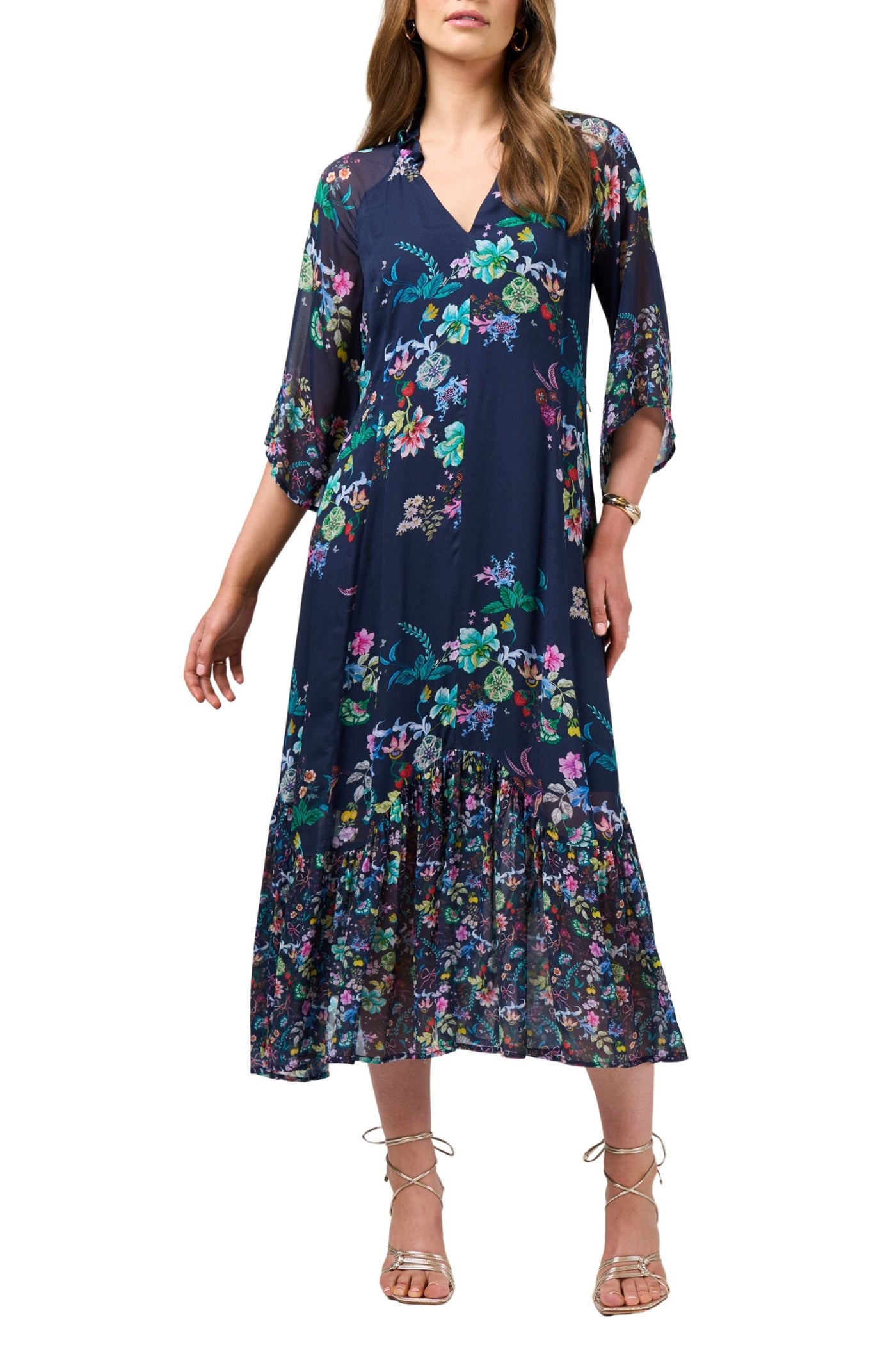 Woman wearing a navy floral dress on a white background
