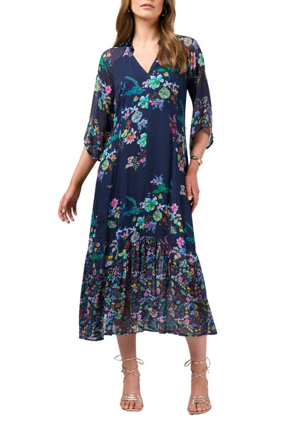 Woman wearing a navy floral dress on a white background