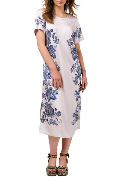 Woman wearing a white dress with blue floral patterns on a white background