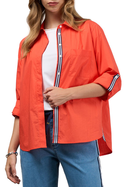 Person wearing an orange jacket with white and black stripes on a white background