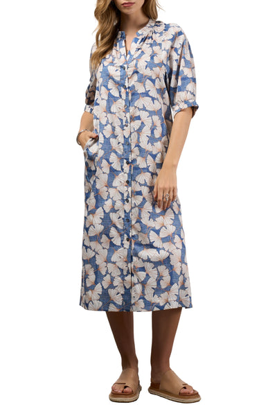 Woman wearing a blue and white floral dress on a white background