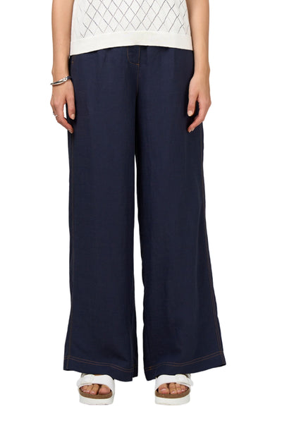 Person wearing navy wide-leg pants on a white background