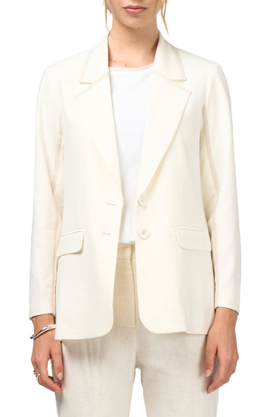 Person wearing a white blazer over a white shirt on a white background